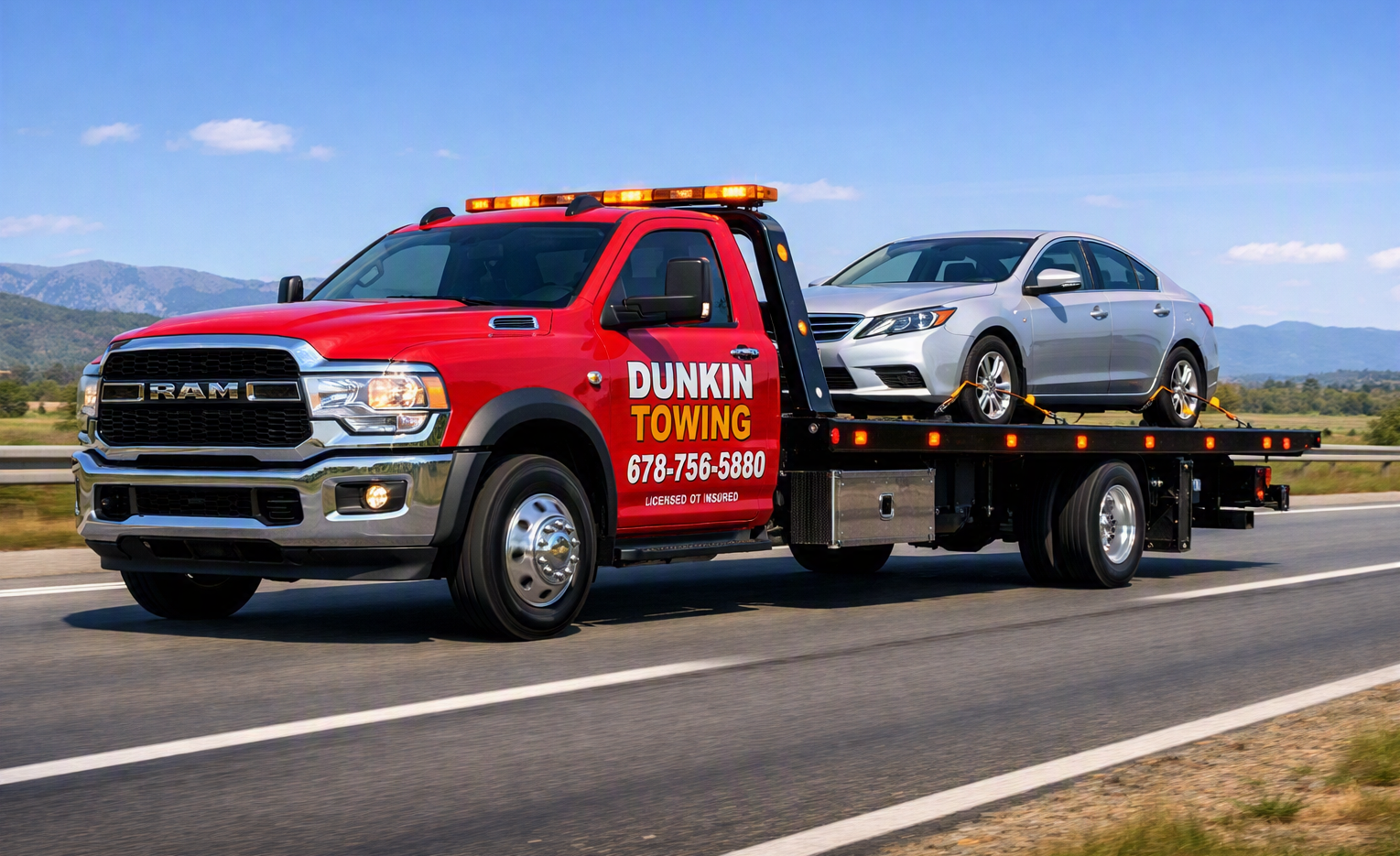 Dunkin Towing truck hauling a car on the highway